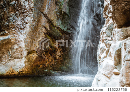 Tranquil Millomeris waterfall cascading down mossy rocks. Cyprus Tranquil Millomeris waterfall cascading down mossy rocks. Cyprus 116228766