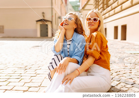 Laughing woman enjoying weekend together. Summer playful mood concept. Laughing woman enjoying weekend together. Summer playful mood concept. 116228805