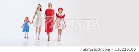 Two beautiful women, mothers with their little daughters wearing elegant retro-fashioned dresses walking and looking around with curiosity. Two beautiful women, mothers with their little daughters wearing elegant retro-fashioned dresses walking and looking around with curiosity. 116229100