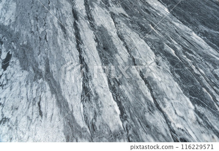 Gray marble texture with natural white veining patterns. Smooth, polished stone surface for countertops 116229571