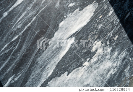 Gray marble texture with natural white veining patterns. Smooth, polished stone surface for countertops 116229934