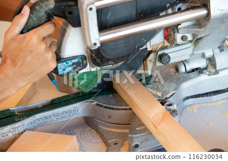 Carpenter working at a new house construction site (wood processing) Carpenter working at a new house construction site (wood processing) 116230034