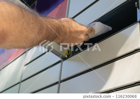 InPost parcel locker branding, modern delivery system, organized compartments, outdoor setting, editorial image 116230068