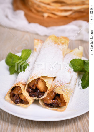 Homemade thin crepe (pancakes) with apple filling Homemade thin crepe (pancakes) with apple filling 116230165