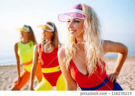Three young woman in bright swimsuits dancing. Sport, summer, fitness, urban culture concept. 116230225