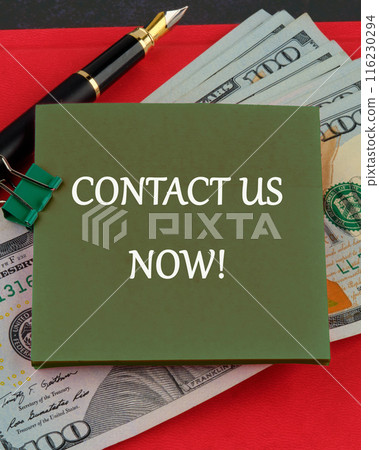 Copy space. Contact us now words written on a green sticker on the background of American dollars Copy space. Contact us now words written on a green sticker on the background of American dollars 116230294