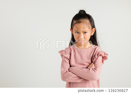 Asian portrait young kid girl standing angry and mad raising fist frustrated and furious while shouting with anger isolated, studio shot on white background, kindergarten child not happy Asian portrait young kid girl standing angry and mad raising fist frustrated and furious while shouting with anger isolated, studio shot on white background, kindergarten child not happy 116230827