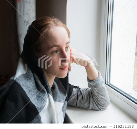 Young girl at old window 116231198