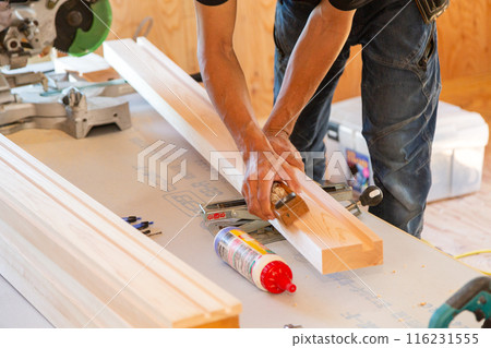 Carpenter working at a new house construction site (planing) 116231555