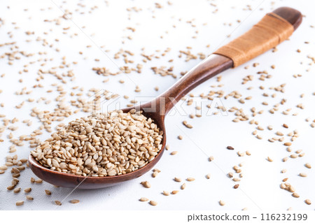 Rolled oats on wooden spoon isolated on white background, healthy breakfast cereal oat flakes  116232199