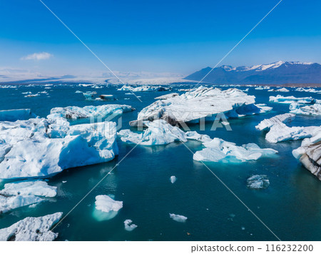 Aerial view of the big pieces of ice from glacier, ice islands, glacier and mountains, Jokulssrlon - Glacier Lagoon. A large glacial lake in southern part of Vatnajokull National Park, Iceland 116232200