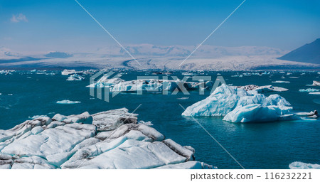 Aerial view of the big pieces of ice from glacier, ice islands, glacier and mountains, Jokulssrlon - Glacier Lagoon. A large glacial lake in southern part of Vatnajokull National Park, Iceland 116232221