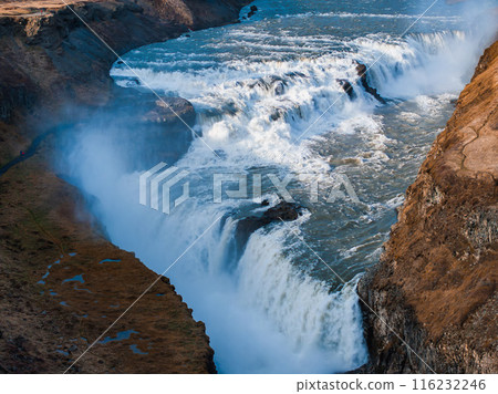 Panoramic summer view of popular tourist destination - Gullfoss waterfall in Iceland. Dramatic aerial view on Hvita river. Incredible morning scene of Iceland, Europe. Panoramic summer view of popular tourist destination - Gullfoss waterfall in Iceland. Dramatic aerial view on Hvita river. Incredible morning scene of Iceland, Europe. 116232246