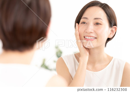 Woman looking in the mirror, beauty, moisture Woman looking in the mirror, beauty, moisture 116232308
