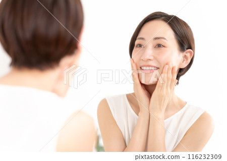 Woman looking in the mirror, beauty, moisture Woman looking in the mirror, beauty, moisture 116232309
