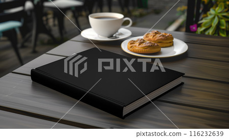 Black book mockup on wooden table with coffee cup and cakes, green trees plants behind 116232639