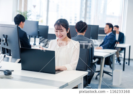 A woman using wireless earphones for a remote meeting in the office 116233168