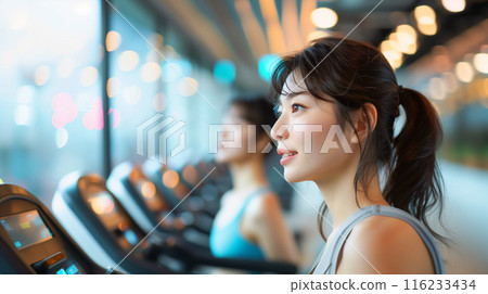A woman running on a running machine 116233434