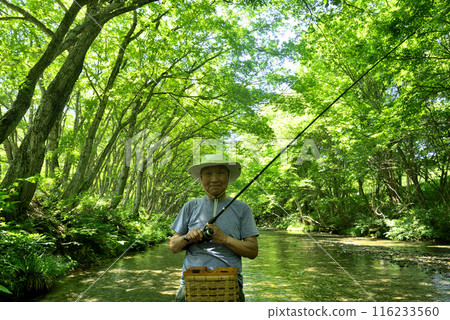 Senior man enjoying mountain stream fishing 116233560