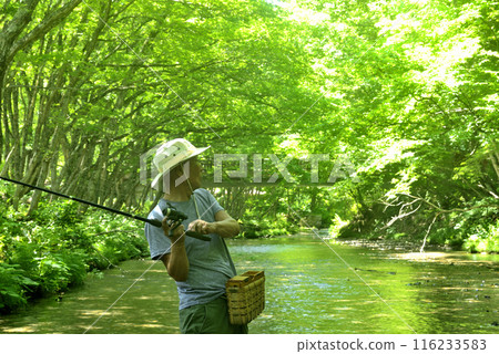 Senior man enjoying mountain stream fishing Senior man enjoying mountain stream fishing 116233583