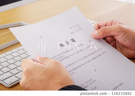 A man staring at a notice 116233882