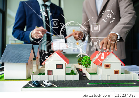 balancing the property sector The real estate agent is explaining the house style to see the house design and the purchase agreement. balancing the property sector The real estate agent is explaining the house style to see the house design and the purchase agreement. 116234383