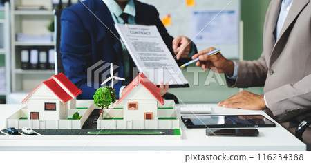 Real estate broker agent presenting and consult to customer to decision making sign insurance form agreement, home model Real estate broker agent presenting and consult to customer to decision making sign insurance form agreement, home model 116234388