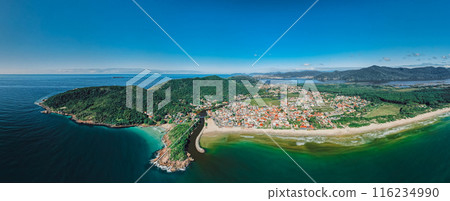 Panoramic view of coastline with beach, mountains and town in Brazil. Drone view of Barra da lagoa in Florianopolis 116234990