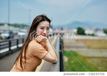 Young woman leaning on her chin and looking at the camera Young woman leaning on her chin and looking at the camera 116235720