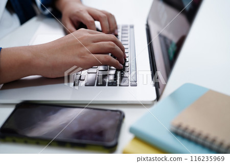 Asian teenage student write homework with laptop computer, learning university education concept. 116235969