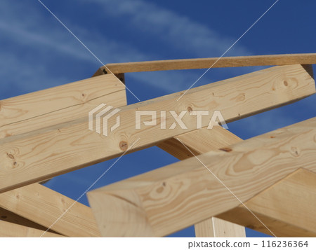 A wooden roof with a blue sky in the background A wooden roof with a blue sky in the background 116236364