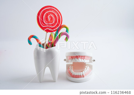 Tooth decay with sweet sugar candy, bad food for dental health care. Tooth decay with sweet sugar candy, bad food for dental health care. 116236468