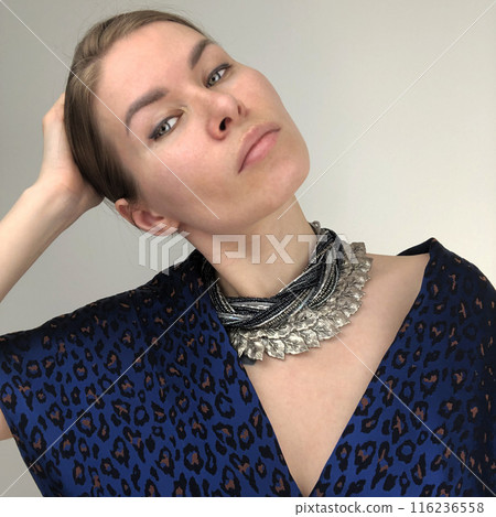 Portrait of a young woman in unusual massive jewelry 116236558