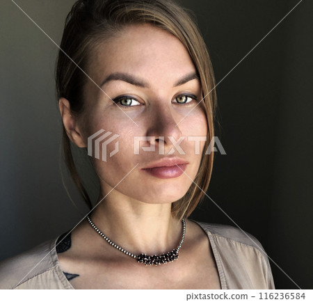 Portrait of a young woman in unusual massive jewelry 116236584