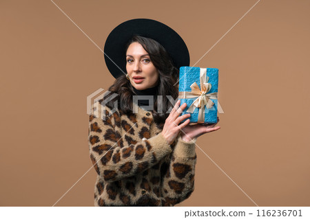 Happy mature woman gift box on beige background. Lady smiling, interested what's inside. Present, offer surprise for you. Happy mature woman gift box on beige background. Lady smiling, interested what's inside. Present, offer surprise for you. 116236701