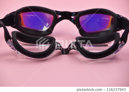Swimming goggles on pink background Swimming goggles on pink background 116237943