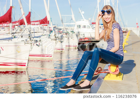 woman in marina against yachts in port 116238076