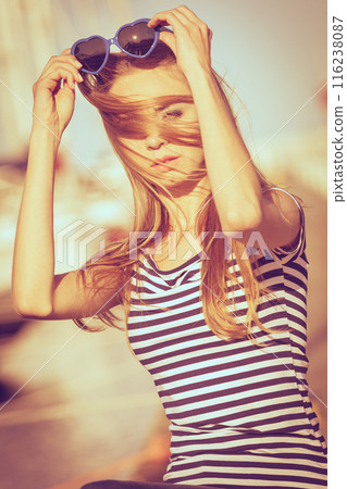 Girl enjoying summer breeze at sunset in marina 116238087