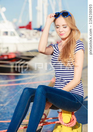 woman in marina against yachts in port woman in marina against yachts in port 116238093