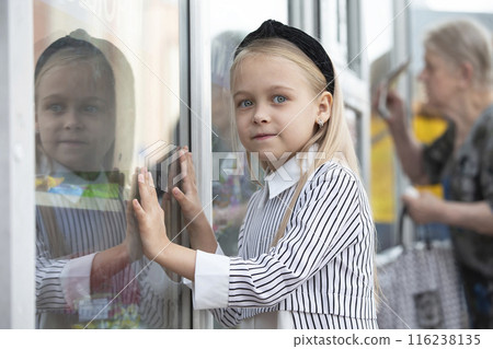 A little girl in the city smiling at the camera. A little girl in the city smiling at the camera. 116238135