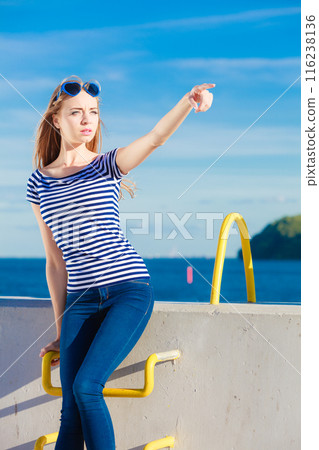woman casual style against stone wall pointing woman casual style against stone wall pointing 116238136