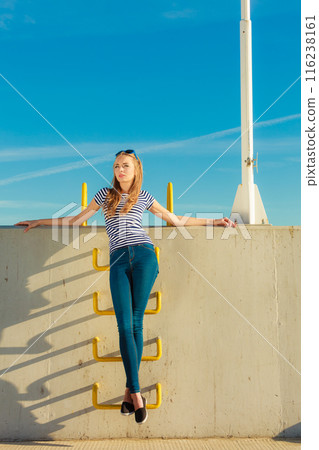 woman casual style against stone wall 116238161