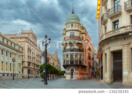 Constitution Avenue in the light of lanterns in the early morning in Seville. 116238191