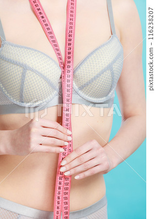 Woman in underwear with measure tape 116238207