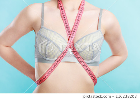 Woman in underwear with measure tape 116238208