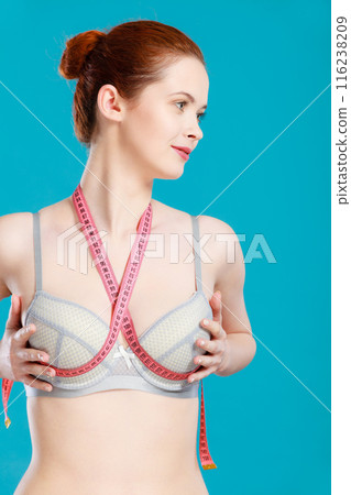 Woman in underwear with measure tape 116238209