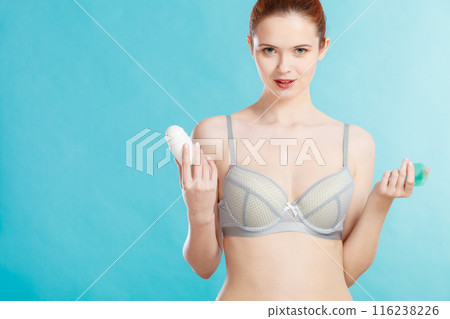 Girl applying stick deodorant in armpit 116238226