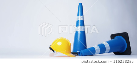 Road traffic safety equipment. Realistic blue traffic cones and yellow safety helmet isolated on white background. Roadside tools for road work or unpredicted automotive accident. Safety first concept 116238283