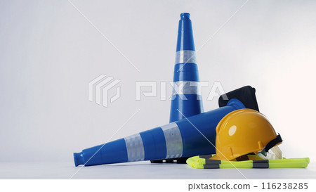 Road traffic safety equipment. Realistic blue traffic cones and yellow safety helmet isolated on white background. Roadside tools for road work or unpredicted automotive accident. Safety first concept 116238285