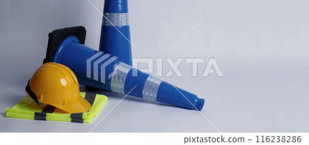 Road traffic safety equipment. Realistic blue traffic cones and yellow safety helmet isolated on white background. Roadside tools for road work or unpredicted automotive accident. Safety first concept 116238286